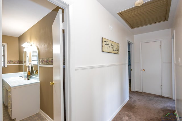 hallway with carpet flooring and sink