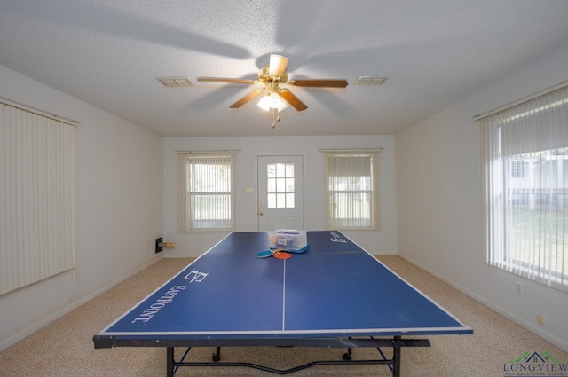 rec room featuring a textured ceiling, carpet floors, and ceiling fan