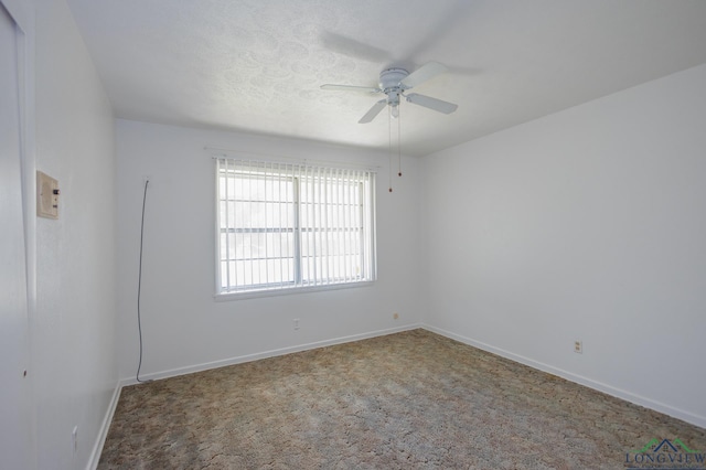 spare room featuring carpet floors and ceiling fan