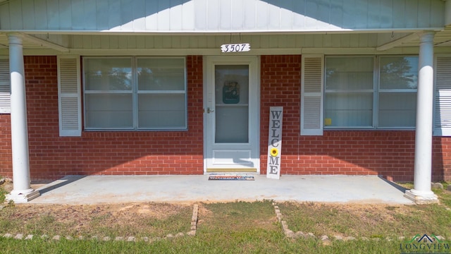 view of exterior entry featuring a porch