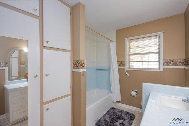 bathroom featuring shower / bath combo and vanity