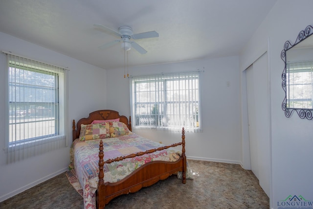 carpeted bedroom with ceiling fan and a closet