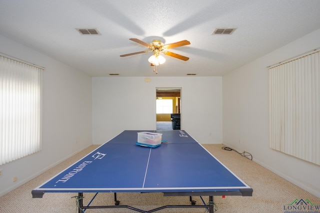 game room with carpet flooring, a textured ceiling, and ceiling fan