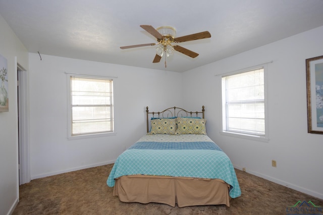 carpeted bedroom featuring multiple windows and ceiling fan