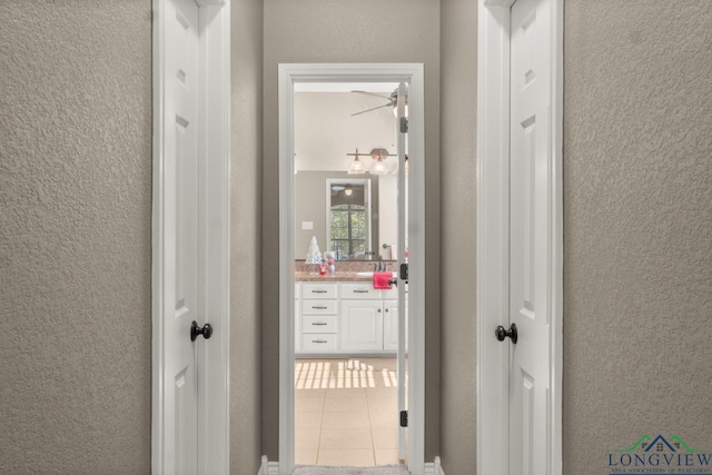 hall featuring light tile patterned flooring