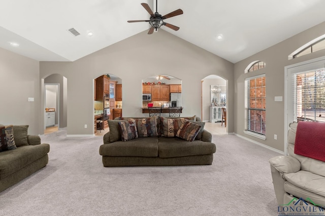 living room featuring ceiling fan, light colored carpet, and high vaulted ceiling