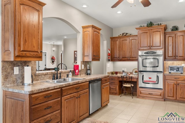 kitchen with ceiling fan, tasteful backsplash, sink, and stainless steel appliances