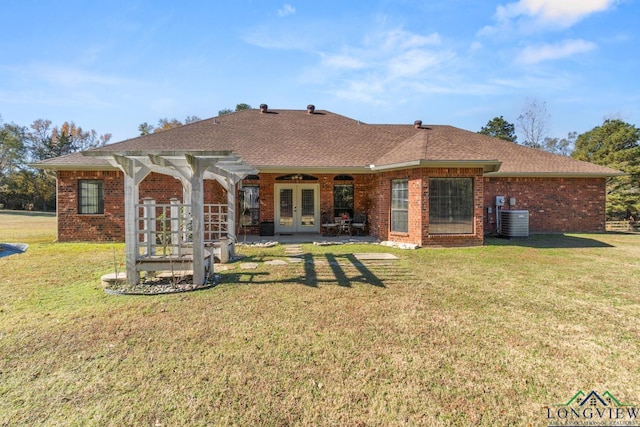 back of property with french doors, a yard, and central AC