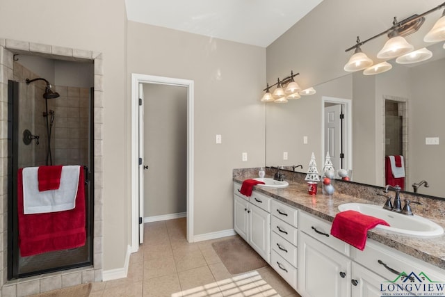 bathroom featuring tile patterned floors, a shower with door, and vanity