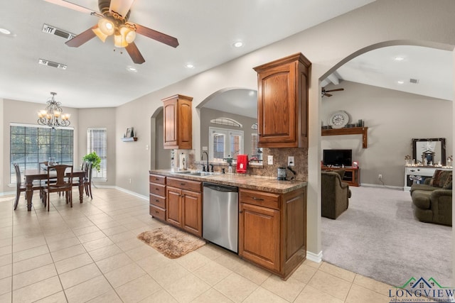 kitchen featuring backsplash, light carpet, ceiling fan with notable chandelier, sink, and stainless steel dishwasher