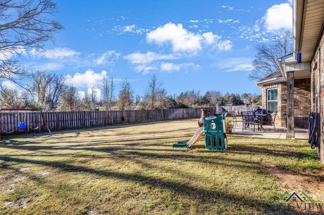 view of yard featuring a playground and a patio