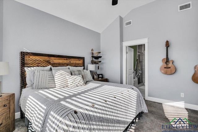 carpeted bedroom with ensuite bathroom and vaulted ceiling