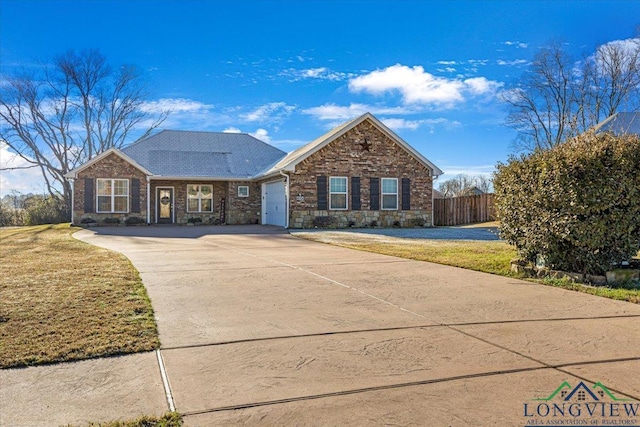 single story home featuring a front yard and a garage