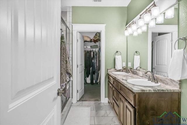 bathroom with vanity and a shower with door