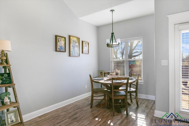 dining space with a chandelier and dark wood-type flooring