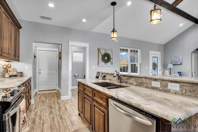 kitchen with appliances with stainless steel finishes, lofted ceiling with beams, light hardwood / wood-style floors, and sink