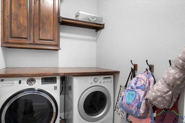 laundry area featuring cabinets and washing machine and clothes dryer