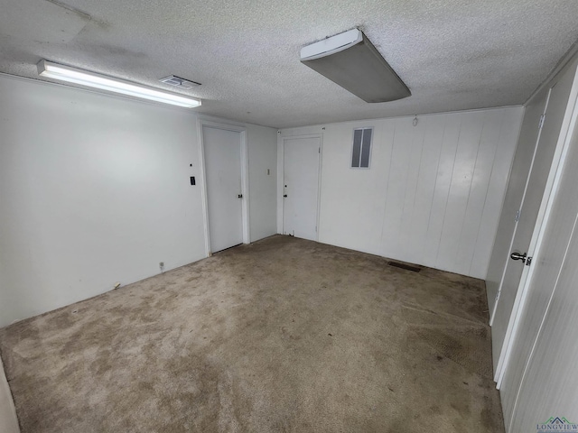 carpeted empty room with a textured ceiling