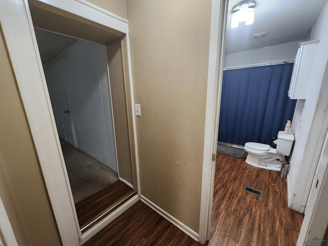 bathroom featuring toilet and hardwood / wood-style flooring