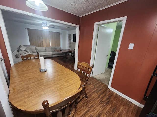 dining area featuring ceiling fan, hardwood / wood-style floors, a textured ceiling, and ornamental molding