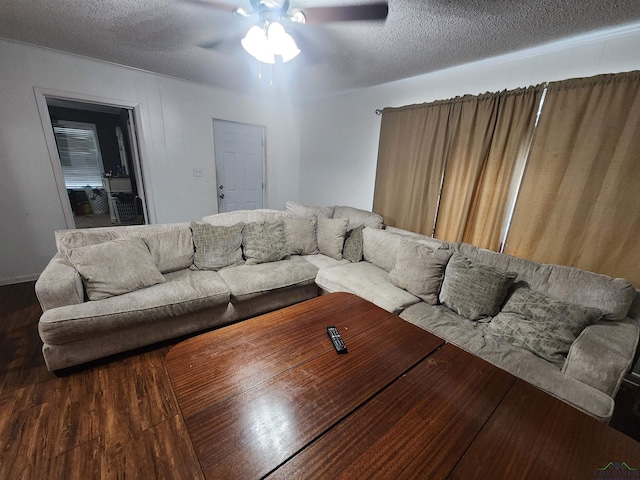 living room featuring a textured ceiling, hardwood / wood-style flooring, and ceiling fan