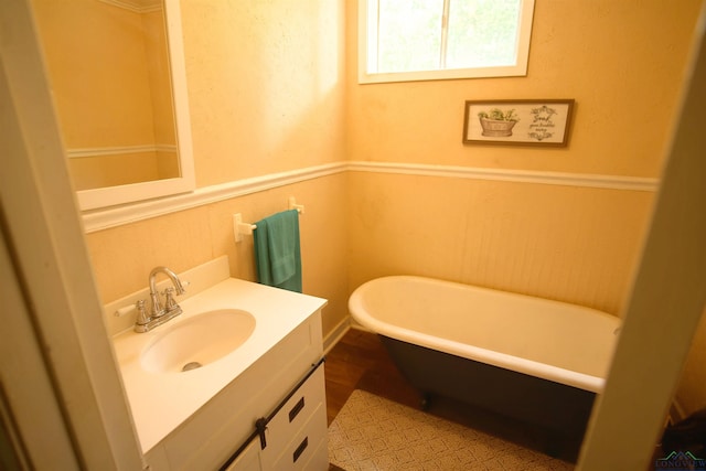 800 E Austin St, Marshall, TX 75670 - bathroom with vanity, a freestanding bath, and a wainscoted wall