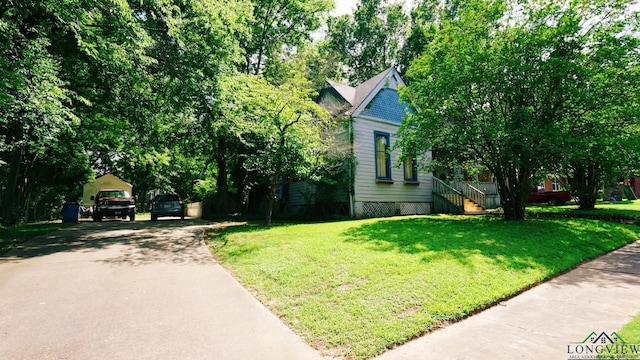 800 E Austin St, Marshall, TX 75670 - view of front of home with asphalt driveway, a front lawn, and a carport