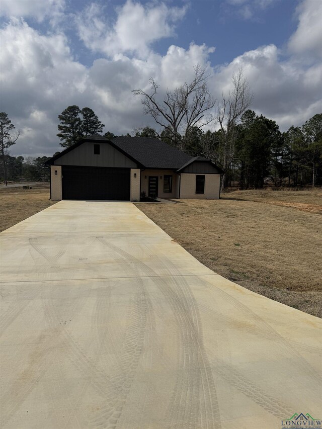 view of front of house with a garage and a front lawn