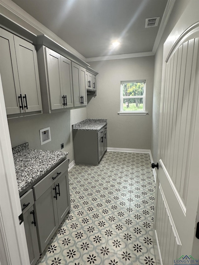 clothes washing area with cabinets, crown molding, hookup for an electric dryer, and washer hookup