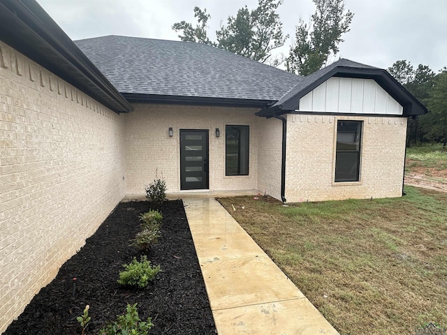 doorway to property with a yard