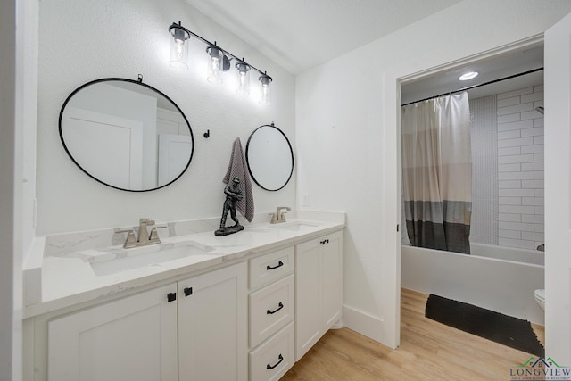 full bathroom with toilet, hardwood / wood-style floors, vanity, and shower / tub combo with curtain