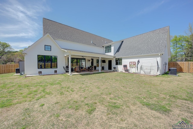 rear view of house with a patio, central AC, ceiling fan, and a lawn