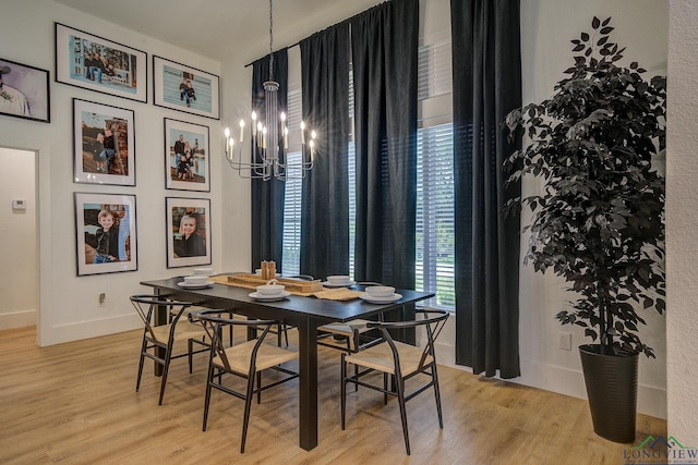 dining space featuring a chandelier and light hardwood / wood-style flooring