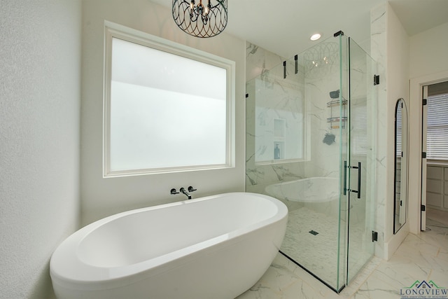 bathroom with plus walk in shower and a chandelier