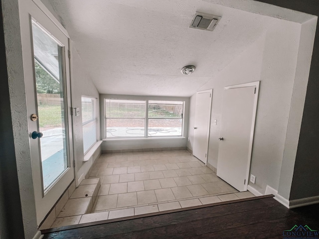 unfurnished sunroom with vaulted ceiling