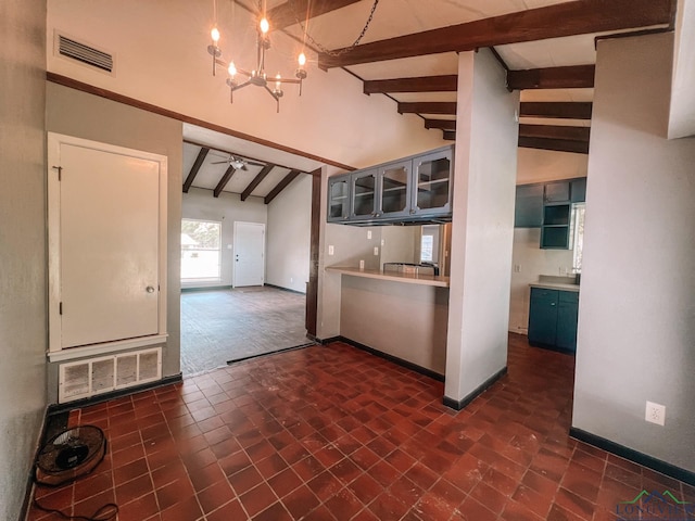 kitchen with vaulted ceiling with beams and ceiling fan with notable chandelier