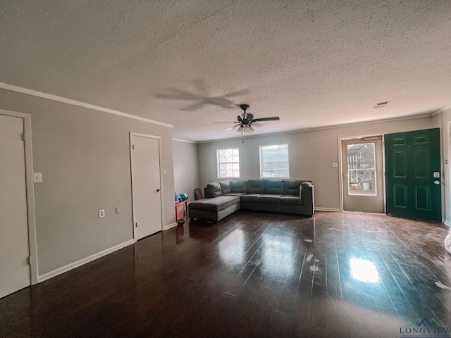 unfurnished living room featuring crown molding, dark hardwood / wood-style flooring, ceiling fan, and a textured ceiling