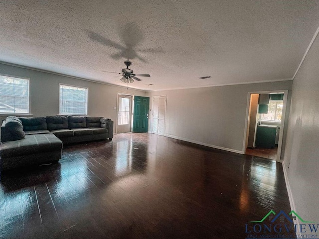 living room featuring ceiling fan, dark hardwood / wood-style flooring, a textured ceiling, and crown molding