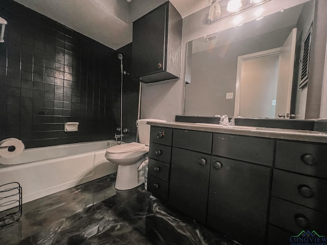 full bathroom with vanity, tiled shower / bath combo, and toilet