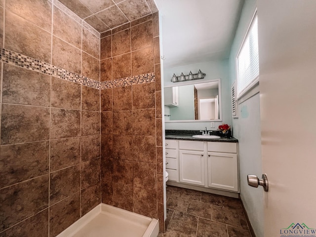 bathroom featuring vanity and tiled shower