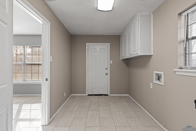 laundry room featuring washer hookup and cabinets