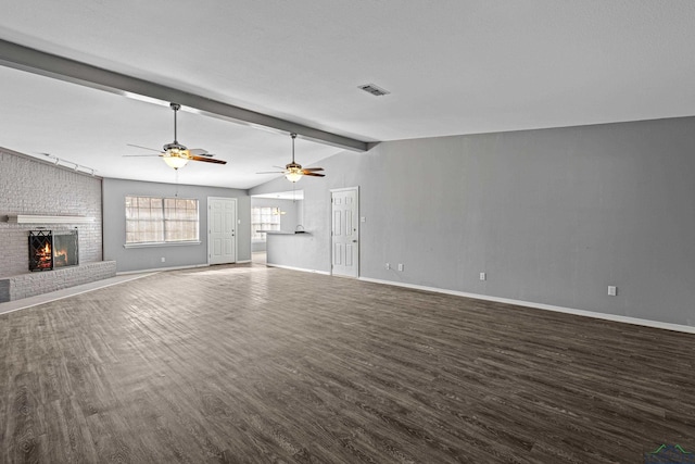 unfurnished living room with a brick fireplace, vaulted ceiling with beams, and ceiling fan