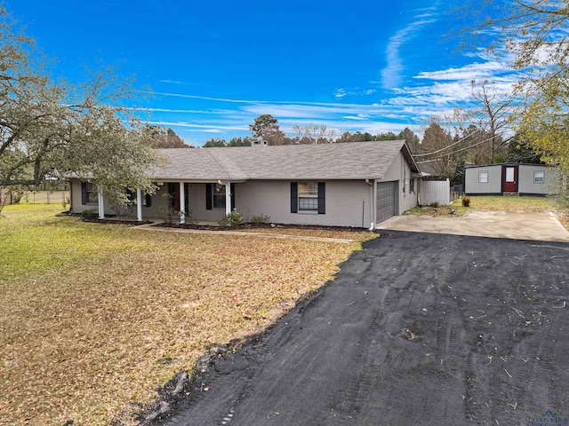 ranch-style home with a front lawn and a garage