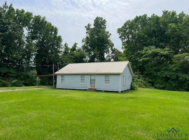 view of outbuilding with a lawn