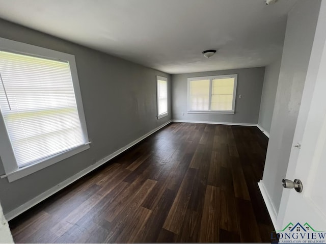 spare room featuring dark wood-type flooring