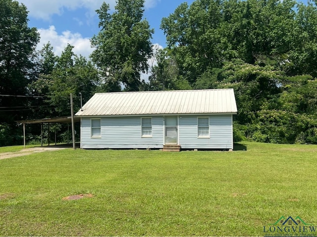 rear view of house with a yard and a carport