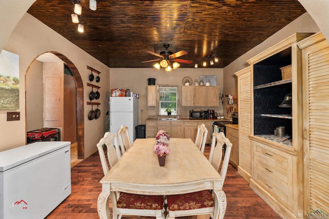 dining room with dark hardwood / wood-style floors, ceiling fan, and wood ceiling