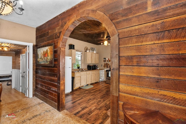 hall featuring sink, dark hardwood / wood-style floors, and wood walls