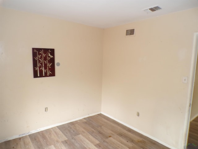 empty room with light hardwood / wood-style floors