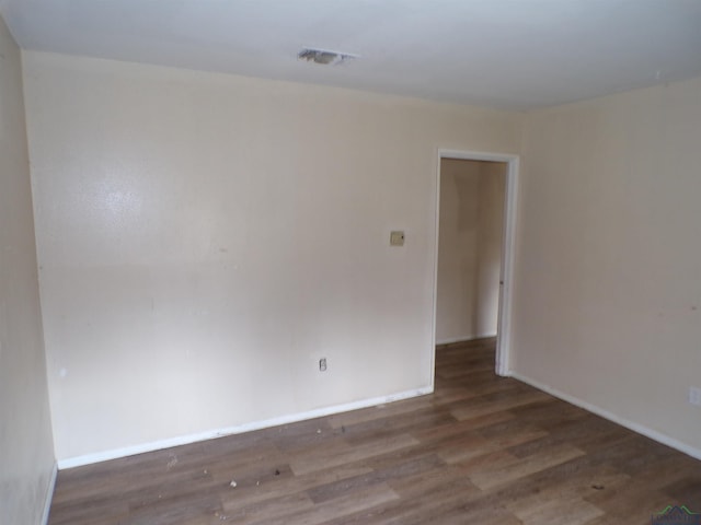 unfurnished room featuring dark hardwood / wood-style floors